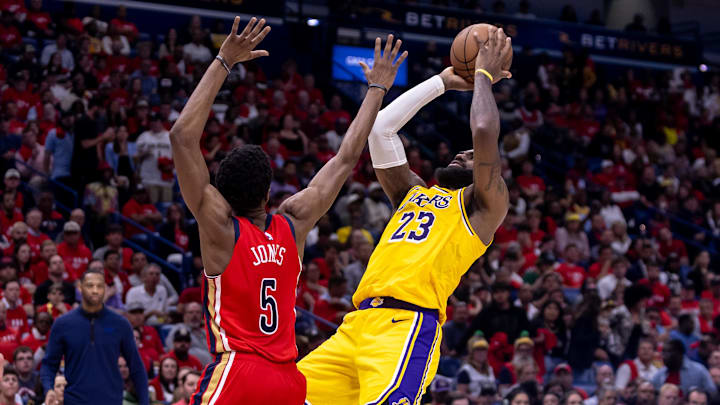 Apr 16, 2024; New Orleans, Louisiana, USA; Los Angeles Lakers forward LeBron James (23) shoots against New Orleans Pelicans forward Herbert Jones (5) during the second half of a play-in game of the 2024 NBA playoffs at Smoothie King Center.