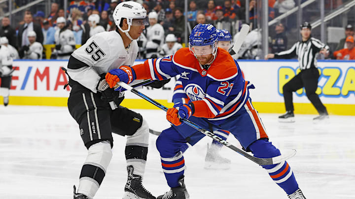 Jan 13, 2025; Edmonton, Alberta, CAN; Los Angeles Kings forward Quinton Byfield (55) and Edmonton Oilers defensemen Brett Kulak (27)  battle for position during the second period at Rogers Place. Mandatory Credit: Perry Nelson-Imagn Images