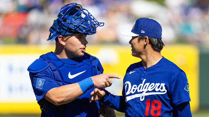 Feb 21, 2026; Tempe, Arizona, USA; Los Angeles Dodgers catcher Dalton Rushing (left) talks with pitcher Yoshinobu Yamamoto against the Los Angeles Angels during a spring training game at Tempe Diablo Stadium. Mandatory Credit: Mark J. Rebilas-Imagn Images