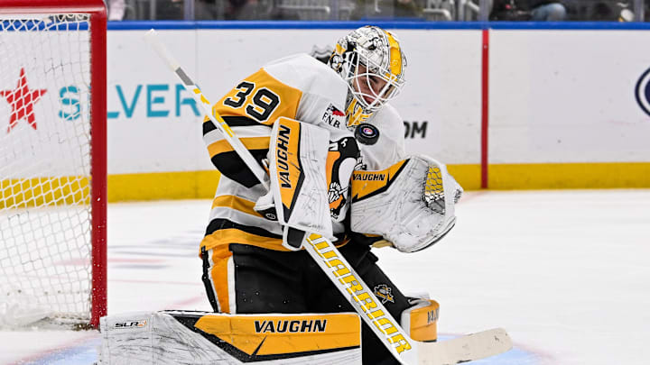 Apr 17, 2024; Elmont, New York, USA;  Pittsburgh Penguins goaltender Alex Nedeljkovic (39) makes a save against the New York Islanders during the second period at UBS Arena. Mandatory Credit: Dennis Schneidler-Imagn Images