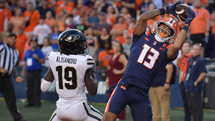 Illinois wide receiver Pat Bryant (13) scores a touchdown catch over Purdue defensive back Botros Alisandro in the second half at Memorial Stadium in Champaign, Ill., on Oct. 12, 2024. 