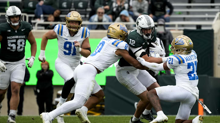 Oct 11, 2025; East Lansing, Michigan, USA; Michigan State tight end Jack Velling (12) runs through the UCLA Bruins defense in the fourth quarter at Spartan Stadium. Mandatory Credit: Brendan Mullin-Imagn Images