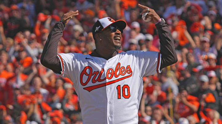 Oct 7, 2023; Baltimore, Maryland, USA; Former Baltimore Orioles outfielder Adam Jones reacts after throwing out the ceremonial first pitch prior to the game against the Texas Rangers during game one of the ALDS for the 2023 MLB playoffs at Oriole Park at Camden Yards. Mandatory Credit: Mitch Stringer-Imagn Images Oct 7, 2023; Baltimore, Maryland, USA; Former Baltimore Orioles outfielder Adam Jones reacts after throwing out the ceremonial first pitch prior to the game against the Texas Rangers during game one of the ALDS for the 2023 MLB playoffs at Oriole Park at Camden Yards. Mandatory Credit: Mitch Stringer-Imagn Images
