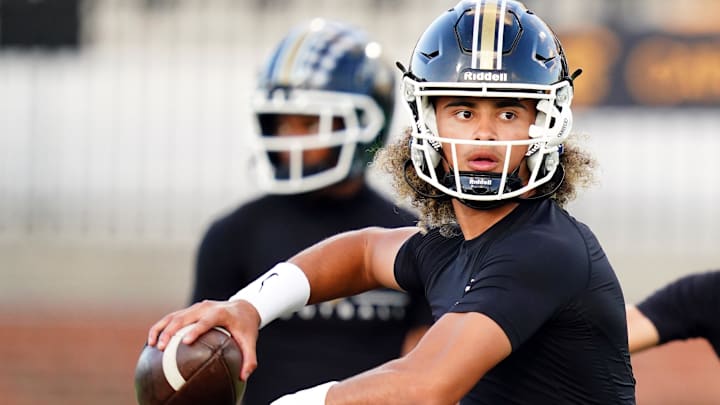 Oct 20, 2023; Carrollton, GA, USA; Carrollton Trojans quarterback Julian Lewis (10) runs through drills during warmups before their game against the Westlake Lions at Grisham Stadium. The 15-year-old Carrollton High student has already committed to playing for the University of Southern California Trojans and has been considered one of the top high school quarterback prospects. 