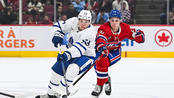 Sep 30, 2023; Montreal, Quebec, CAN; Toronto Maple Leafs right wing Easton Cowan (53) plays the puck against Montreal Canadiens left wing Juraj Slafkovsky (20) during the first period at Bell Centre. Mandatory Credit: David Kirouac-Imagn Images