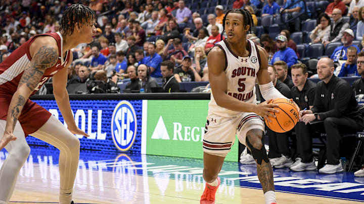 Mar 14, 2024; Nashville, TN, USA; South Carolina Gamecocks guard Meechie Johnson (5) looks to pass the ball past an Arkansas defender