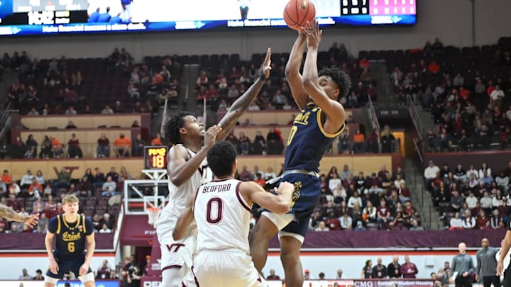 Jan 17, 2026; Blacksburg, Va.; Notre Dame guard Brady Stevens (0) shoots a shot as Virginia Tech forward Amani Hansberry (13) and guard Jailen Bedford (0) defend.