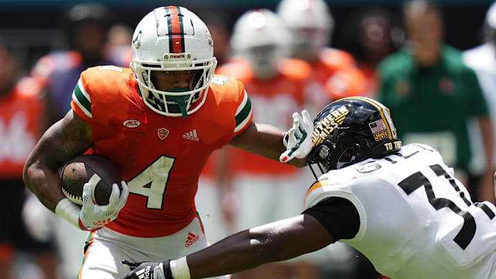 Sep 10, 2022; Miami Gardens, Florida, USA; Southern Miss Golden Eagles linebacker Daylen Gill (31) attempts to bring down Miami Hurricanes running back Jaylan Knighton (4) during the first half at Hard Rock Stadium. Mandatory Credit: Jasen Vinlove-Imagn Images