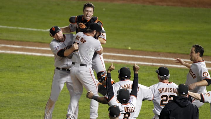 Nov 1, 2010; Arlington, TX, USA; San Francisco Giants relief pitcher Brian Wilson (38) celebrates with first baseman Aubrey Huff (left) and catcher Buster Posey (top) after defeating the Texas Rangers 3-1 in game five of the 2010 World Series at Rangers Ballpark. The Giants won the series four games to one.  Mandatory Credit: Tim Heitman-Imagn Images