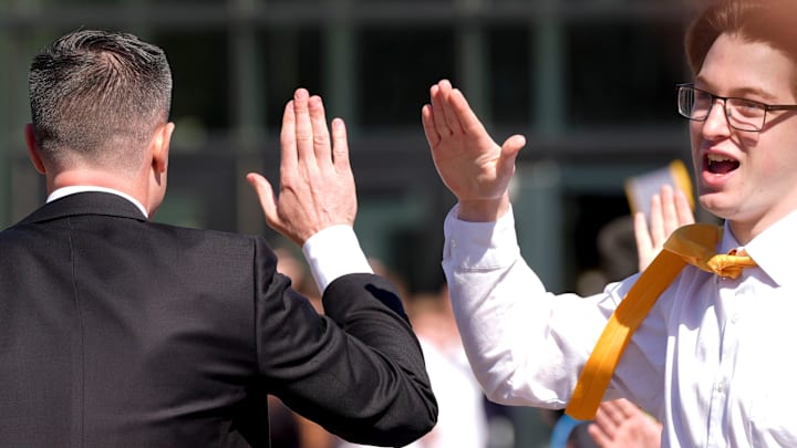 Iowa's new head men's basketball coach Ben McCollum high-fives a crowd member while walking into his introductory press conference Tuesday, March 25, 2025 at Carver-Hawkeye Arena in Iowa City, Iowa.