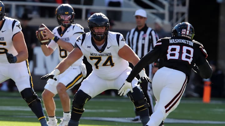 Nov 30, 2024; Lubbock, Texas, USA;  West Virginia Mountaineers offensive lineman Wyatt Milum (74) prepares to block Texas Tech Red Raiders back Amier Washington (88) in the first half at Jones AT&T Stadium and Cody Campbell Field. Mandatory Credit: Michael C. Johnson-Imagn Images