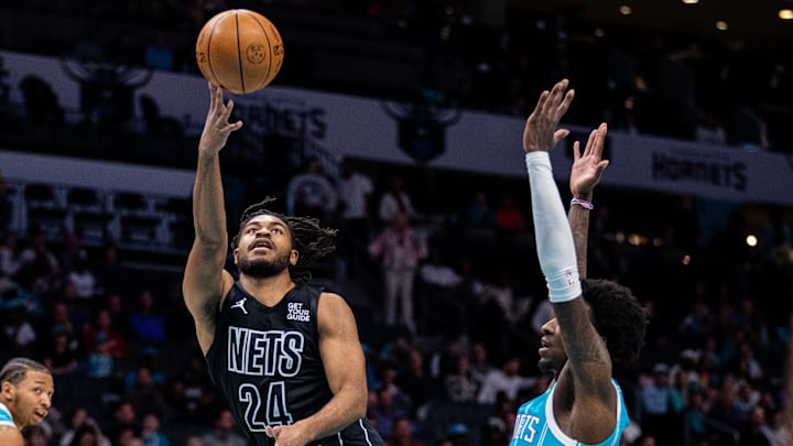 Mar 8, 2025; Charlotte, North Carolina, USA; Brooklyn Nets guard Cam Thomas (24) shoots on Charlotte Hornets guard Damion Baugh (7) during the first quarter at Spectrum Center. Mandatory Credit: Scott Kinser-Imagn Images