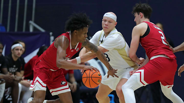 Northern Illinois Huskies guard Jones gets around Akron Zips guard Gray during the second half of an NCAA college basketball game on Tuesday, Feb. 18, 2025, in Akron, Ohio.