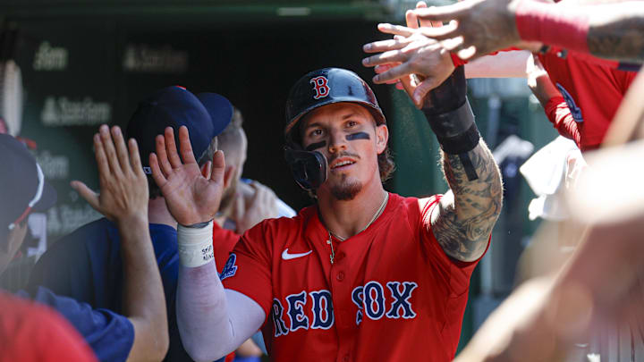 Jul 18, 2025; Chicago, Illinois, USA; Boston Red Sox left fielder Jarren Duran (16) celebrates with teammates in the dugout after scoring against the Chicago Cubs during the third inning at Wrigley Field. Mandatory Credit: Kamil Krzaczynski-Imagn Images