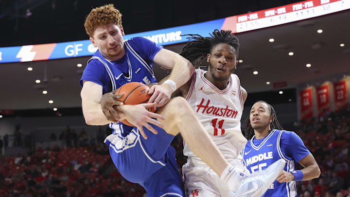 Dec 29, 2025; Houston, Texas, USA; Middle Tennessee Blue Raiders forward Chris Loofe (13) and Houston Cougars forward Joseph Tugler (11) battle for a loose ball during the second half at Fertitta Center. 