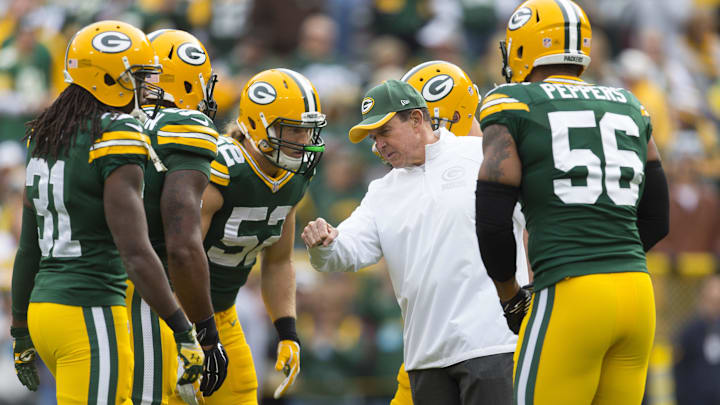Oct 19, 2014; Green Bay, WI, USA; Green Bay Packers defensive coordinator Dom Capers talks with the defense during warmups prior to the game against the Carolina Panthers at Lambeau Field. Mandatory Credit: Jeff Hanisch-Imagn Images