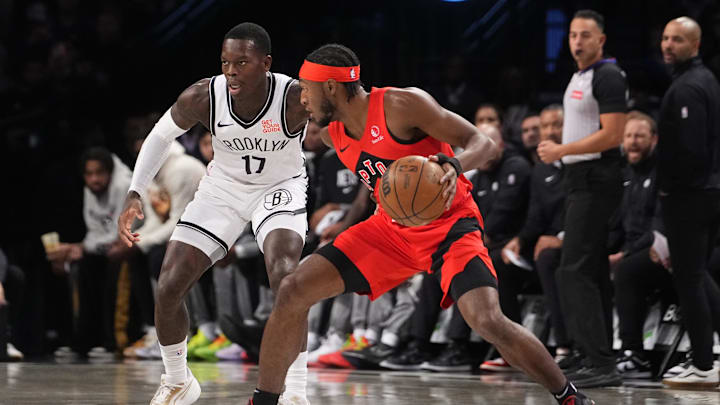 Oct 18, 2024; Brooklyn, New York, USA; Toronto Raptors shooting guard Immanuel Quickley (5) dribbles the ball against Brooklyn Nets point guard Dennis Schroder (17) during the first half at Barclays Center. Mandatory Credit: Gregory Fisher-Imagn Images