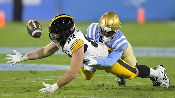 Nov 8, 2024; Pasadena, California, USA;   UCLA Bruins defensive back K.J. Wallace (7) defends Iowa Hawkeyes tight end Johnny Pascuzzi (82) forcing an incomplete pass in the first half at the Rose Bowl. Mandatory Credit: Jayne Kamin-Oncea-Imagn Images