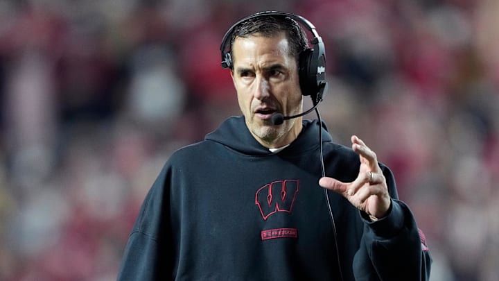 Nov 22, 2025; Madison, Wisconsin, USA; Wisconsin Badgers head coach Luke Fickell talks to his team during the second half against the Illinois Fighting Illini at Camp Randall Stadium.