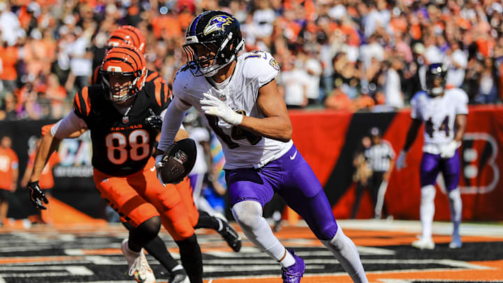 Oct 6, 2024; Cincinnati, Ohio, USA; Baltimore Ravens safety Kyle Hamilton (14) runs with the ball against Cincinnati Bengals tight end Mike Gesicki (88) in the first half at Paycor Stadium. Mandatory Credit: Katie Stratman-Imagn Images
