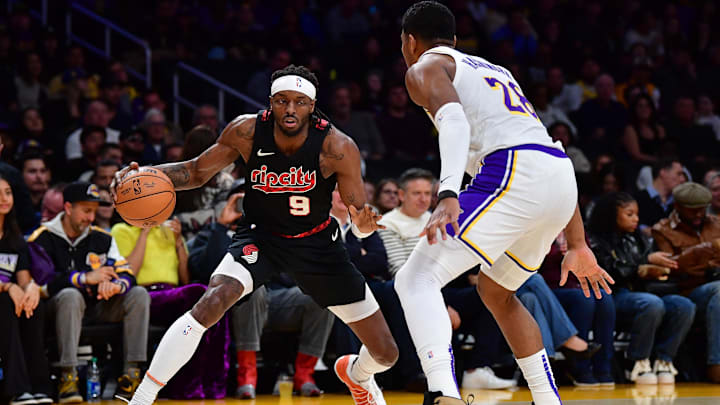 Jan 21, 2024; Los Angeles, California, USA; Portland Trail Blazers forward Jerami Grant (9) controls the ball against Los Angeles Lakers forward Rui Hachimura (28) during the first half at Crypto.com Arena. Mandatory Credit: Gary A. Vasquez-Imagn Images