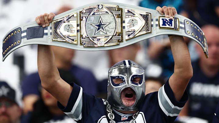 A Dallas Cowboys fan holds up a belt in support of the team before the game against the New York Giants.