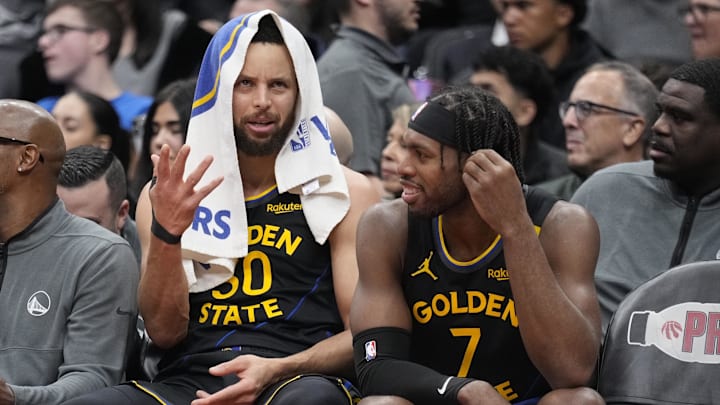 Jan 13, 2025; Toronto, Ontario, CAN; Golden State Warriors guard Stephen Curry (30) and guard Buddy Hield (7) talk on the bench during the second half against the Toronto Raptors at Scotiabank Arena. Mandatory Credit: John E. Sokolowski-Imagn Images