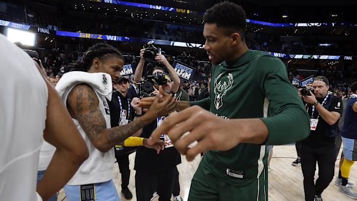 Dec 15, 2022; Memphis, Tennessee, USA; Memphis Grizzlies guard Ja Morant (left) and Milwaukee Bucks forward Giannis Antetokounmpo (34) shake hands after the game at FedExForum. Mandatory Credit: Petre Thomas-Imagn Images