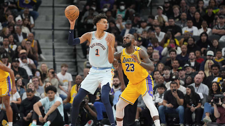 Nov 27, 2024; San Antonio, Texas, USA;  San Antonio Spurs center Victor Wembanyama (1) handles the ball in front of Los Angeles Lakers forward LeBron James (23) in the second half at Frost Bank Center. Mandatory Credit: Daniel Dunn-Imagn Images