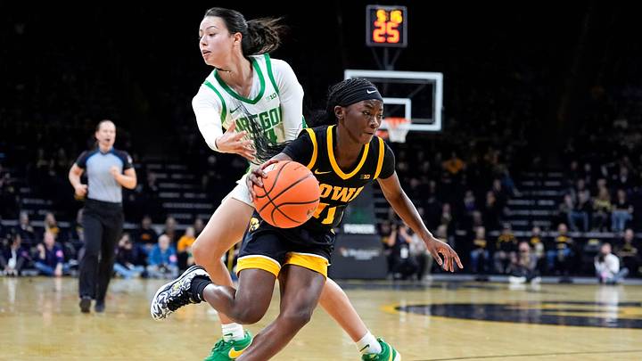 Iowa guard Chit-Chat Wright (11) drives past Oregon guard Ari Long (14) Jan. 15, 2026 at Carver-Hawkeye Arena in Iowa City, Iowa.