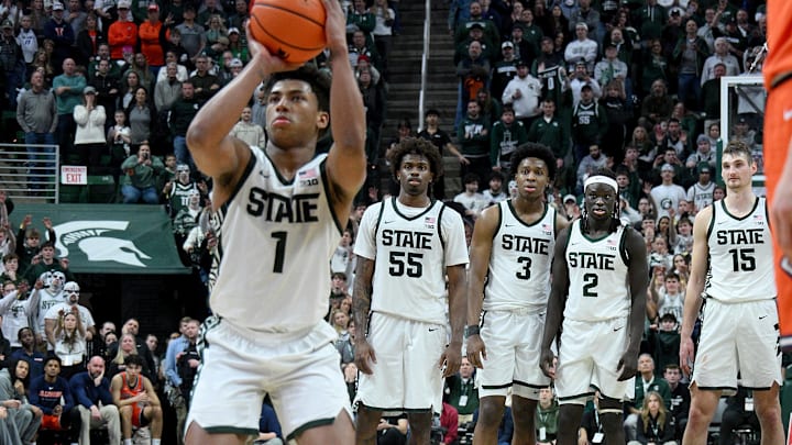 Feb 7, 2026; East Lansing, Michigan, USA;  Michigan State Spartans guard Jeremy Fears Jr. (1) shoots free throws in overtime while his teammates watch in their game against the Illinois Fighting Illini at Jack Breslin Student Events Center. Mandatory Credit: Dale Young-Imagn Images