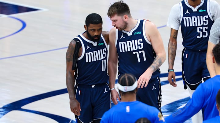 Dallas Mavericks guard Kyrie Irving (11) reacts with Dallas Mavericks guard Luka Doncic.