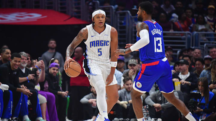 Oct 31, 2023; Los Angeles, California, USA; Orlando Magic forward Paolo Banchero (5) controls the ball against Los Angeles Clippers forward Paul George (13) during the first half at Crypto.com Arena. Mandatory Credit: Gary A. Vasquez-Imagn Images