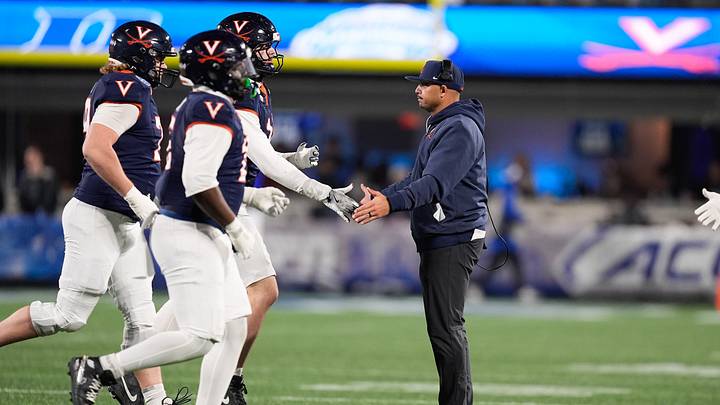 Dec 6, 2025; Charlotte, NC, USA; Virginia Cavaliers head coach Tony Elliott greets players during the second half against the Duke Blue Devils during the 2025 ACC Championship game at Bank of America Stadium. Mandatory Credit: Jim Dedmon-Imagn Images Dec 6, 2025; Charlotte, NC, USA; Virginia Cavaliers head coach Tony Elliott greets players during the second half against the Duke Blue Devils during the 2025 ACC Championship game at Bank of America Stadium. Mandatory Credit: Jim Dedmon-Imagn Images