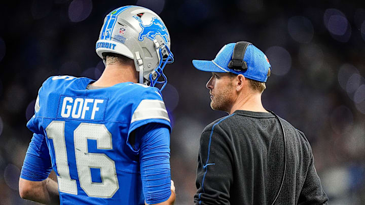 Detroit Lions quarterback Jared Goff (16), left, talks to offensive coordinator Ben Johnson before a play against Chicago Bears during the first half at Ford Field in Detroit on Thursday, Nov. 28, 2024.