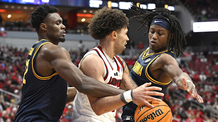 Mar 5, 2025; Louisville, Kentucky, USA;  California Golden Bears center Mady Sissoko (12) and guard DJ Campbell (3) double team Louisville Cardinals guard J'Vonne Hadley (1) during the second half at KFC Yum! Center. Louisville defeated California 85-68. Mandatory Credit: Jamie Rhodes-Imagn Images