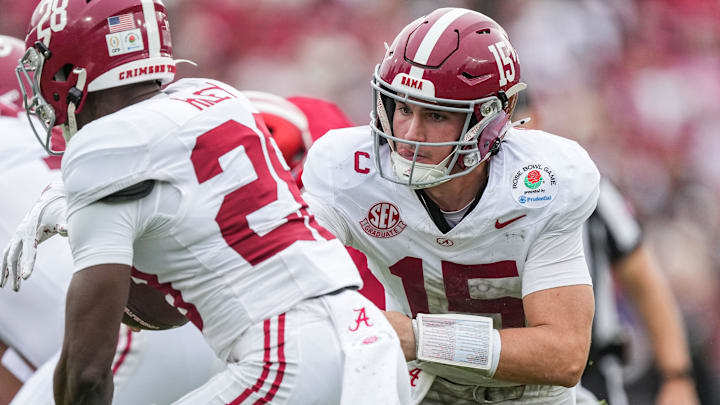 Alabama Crimson Tide quarterback Ty Simpson (15) hands off the ball to Alabama Crimson Tide running back Kevin Riley (28) on Thursday, Jan. 1, 2026, during the 112th annual Rose Bowl game in Pasadena. Indiana Hoosiers defeated Alabama Crimson Tide, 38-3.