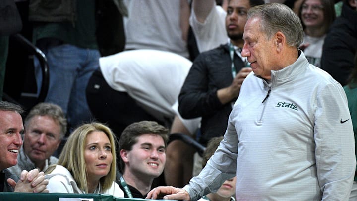 Dec 2, 2025; East Lansing, Michigan, USA; MSU’s new football coach, Pat Fitzgerald(left) chats with at Michigan State Spartans head coach Tom Izzo during their game against Iowa at Jack Breslin Student Events Center. Mandatory Credit: Dale Young-Imagn Images Dec 2, 2025; East Lansing, Michigan, USA; MSU’s new football coach, Pat Fitzgerald(left) chats with at Michigan State Spartans head coach Tom Izzo during their game against Iowa at Jack Breslin Student Events Center. Mandatory Credit: Dale Young-Imagn Images