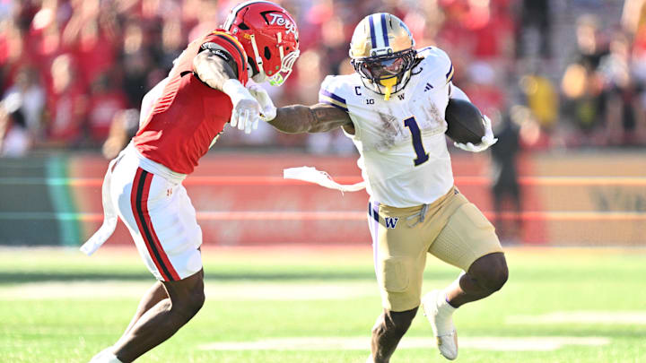 Jonah Coleman (1) stiff arms Maryland linebacker Trey Reddick (3); Jonah Coleman (1) stiff arms Maryland linebacker Trey Reddick (3);