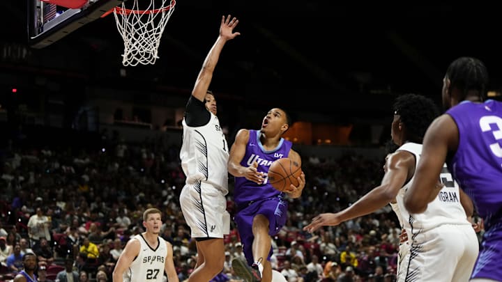 Jul 14, 2025; Las Vegas, NV, USA;  Utah Jazz forward John Tonje (17) drives towards the basket against San Antonio Spurs forward Carter Bryant (11) during the first half of a NBA basketball game at the Thomas & Mack Center. Mandatory Credit: Lucas Peltier-Imagn Images