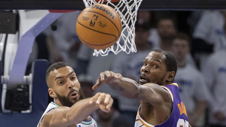 Apr 20, 2024; Minneapolis, Minnesota, USA; Minnesota Timberwolves center Rudy Gobert (27) and Phoenix Suns forward Kevin Durant (35) jump for a rebound in the first half during game one of the first round for the 2024 NBA playoffs at Target Center. Mandatory Credit: Jesse Johnson-Imagn Images