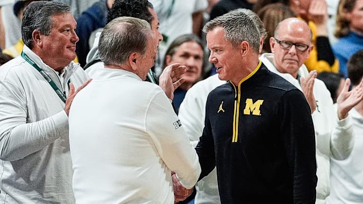 Michigan State head coach Tom Izzo, left, shakes hands with Michigan head coach Dusty May after 79-62 win at Breslin Center in East Lansing on Sunday, March 9, 2025.