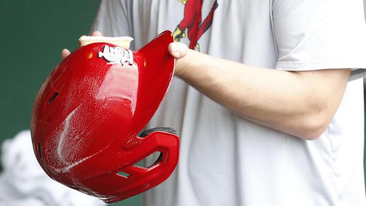 Jul 3, 2024; Pittsburgh, Pennsylvania, USA;  A St. Louis Cardinals equipment manager shines the batting helmets prior to a game against the Pittsburgh Pirates at PNC Park. Mandatory Credit: Charles LeClaire-Imagn Images