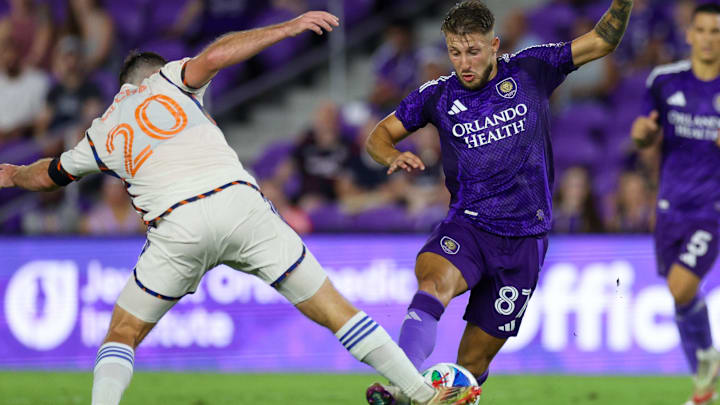 Jun 28, 2025; Orlando, Florida, USA; FC Cincinnati midfielder Pavel Bucha (20) and Orlando City forward Marco Pasalic (87) battle for the ball in the second half at Inter&Co Stadium. Mandatory Credit: Nathan Ray Seebeck-Imagn Images
