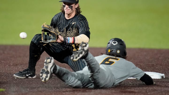 Missouri left fielder Jeric Curtis (6) steals second base under Vanderbilt infielder Jonathan Missouri left fielder Jeric Curtis (6) steals second base under Vanderbilt infielder Jonathan