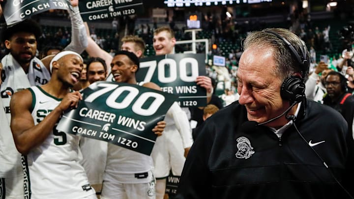 Michigan State players celebrate head coach Tom Izzo's 700 career win as head coach Tom Izzo is being interviewed after 81-62 win over Michigan at Breslin Center in East Lansing on Tuesday, Jan. 30, 2024.