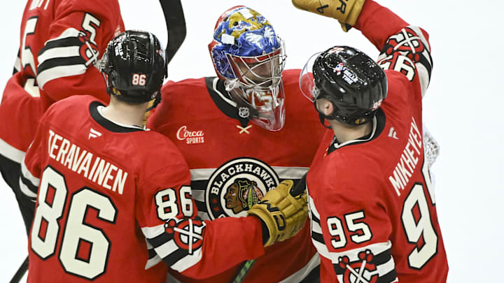 Mar 7, 2025; Chicago, Illinois, USA;   Chicago Blackhawks goaltender Spencer Knight (30) celebrates with center Teuvo Teravainen (86) and right wing Ilya Mikheyev (95) after the overtime period  against the Utah Hockey Club at the United Center. Mandatory Credit: Matt Marton-Imagn Images