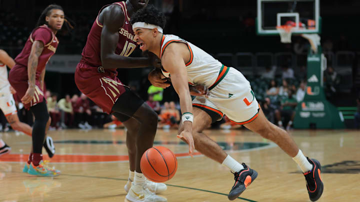 Jan 8, 2025; Coral Gables, Florida, USA; Miami Hurricanes guard Jalen Blackmon (5) drives to the basket past Florida State Seminoles forward Taylor Bol Bowen (10) during the second half at Watsco Center. Mandatory Credit: Sam Navarro-Imagn Images