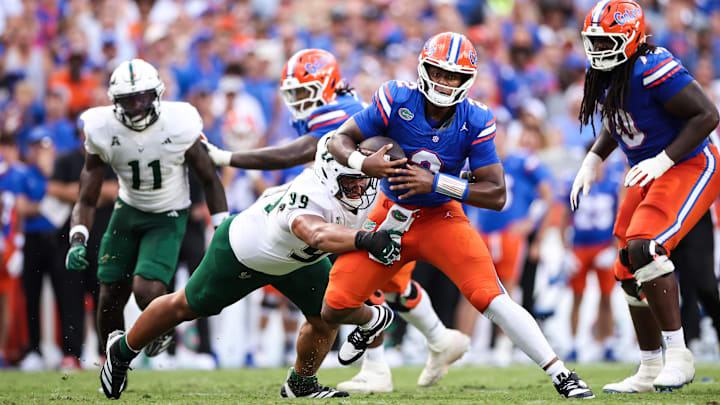 Gator quarterback DJ Lagway is tackled by USF defensive tackle Devin Lee in The Swamp Saturday.