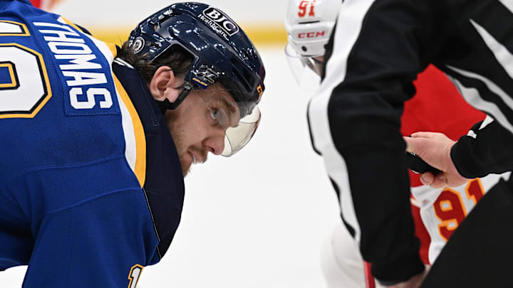 Jan 14, 2025; St. Louis, Missouri, USA; St. Louis Blues center Robert Thomas (18) eyes the puck prior to a face off against the Calgary Flames in the third period at Enterprise Center. Mandatory Credit: Joe Puetz-Imagn Images